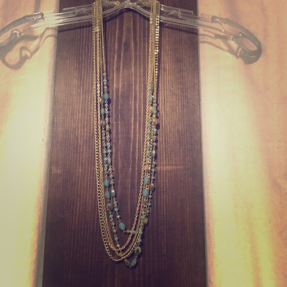 Gold tone and turquoise cling necklace.